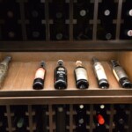 Wine bottles come in various shapes and sizes. This display row highlights and showcases some of the more beautiful bottles in this collection.