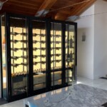 Custom LED backpanels are a dramatic and striking addition to modern Dallas-Fort Worth wine cellars like this one.